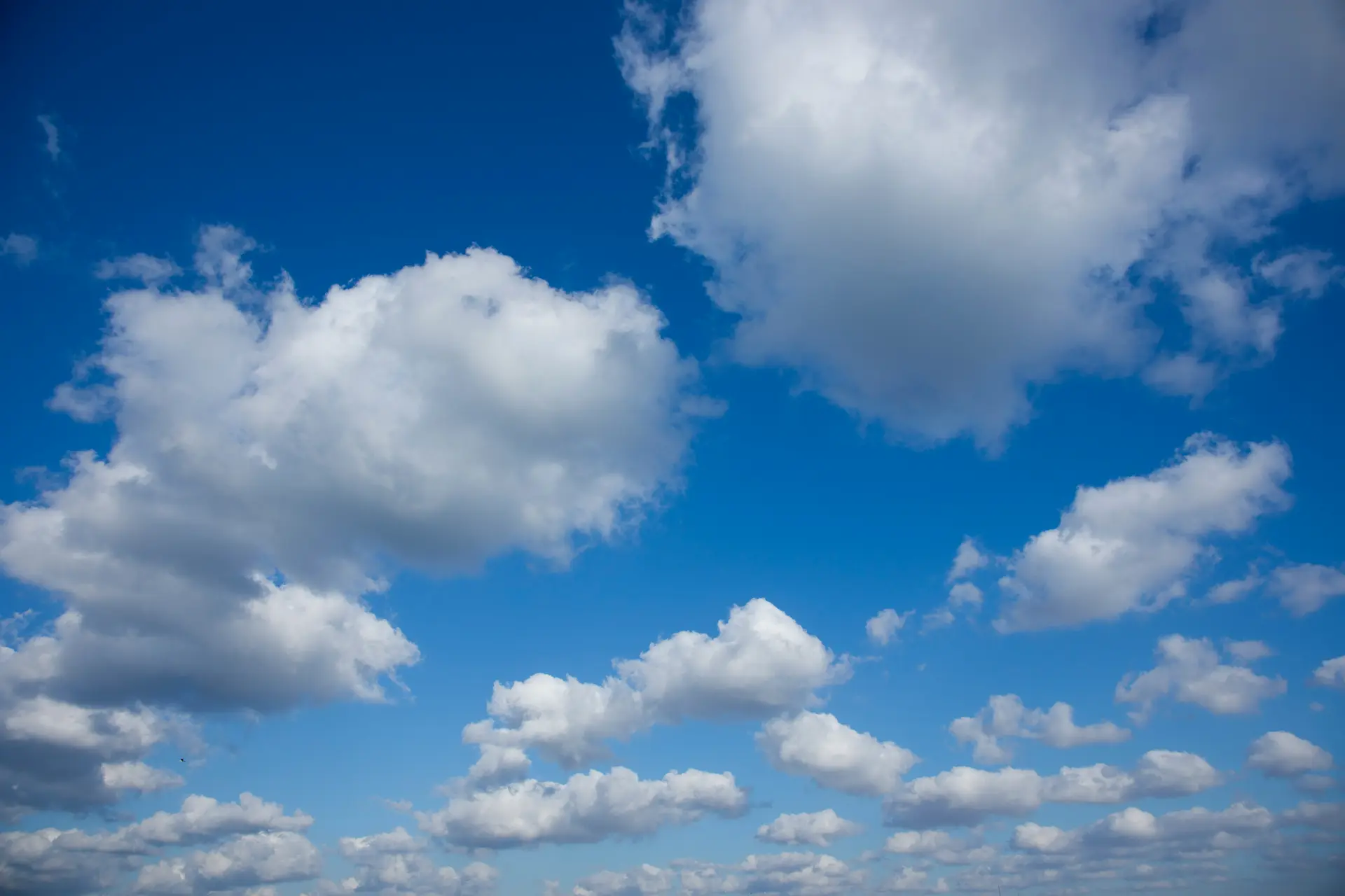 White clouds across a deep blue sky